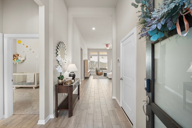 hall featuring wood finish floors and baseboards