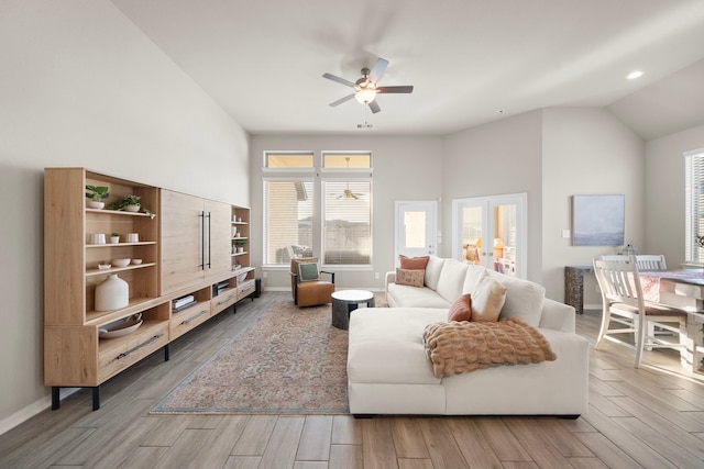 living room featuring french doors, wood finish floors, a wealth of natural light, and baseboards