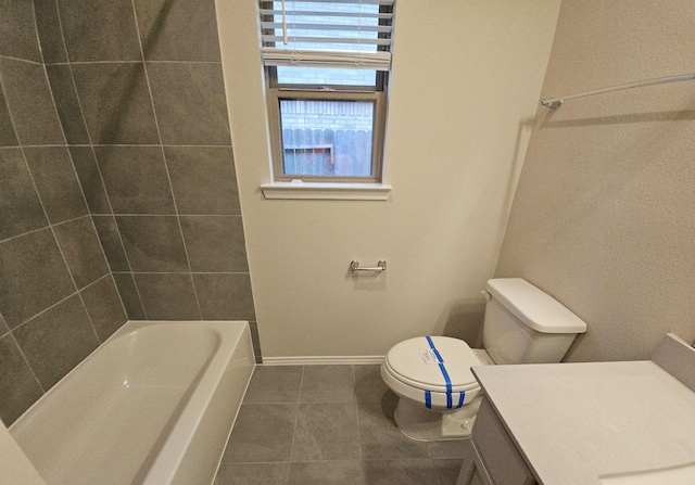 bathroom featuring toilet, vanity, baseboards, and tile patterned floors