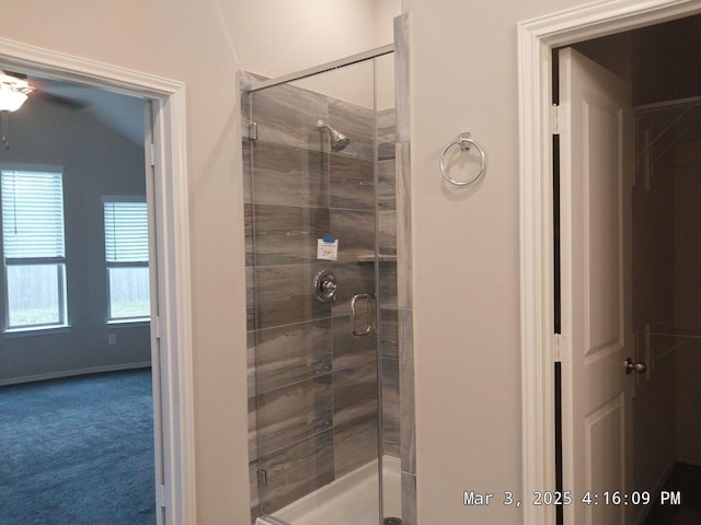 bathroom with a stall shower and baseboards