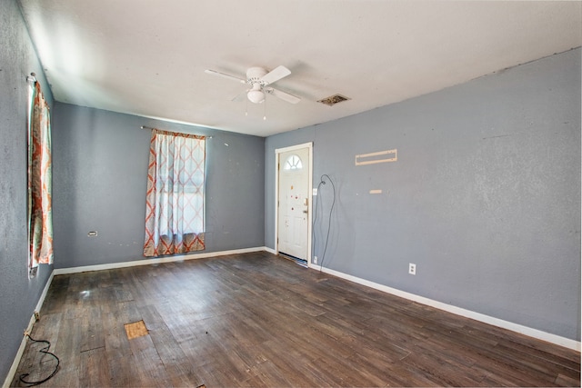 foyer with a ceiling fan, wood finished floors, visible vents, and baseboards