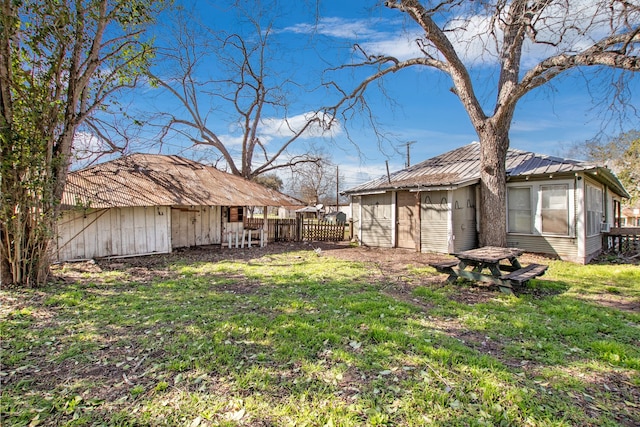 view of yard featuring fence and an outdoor structure