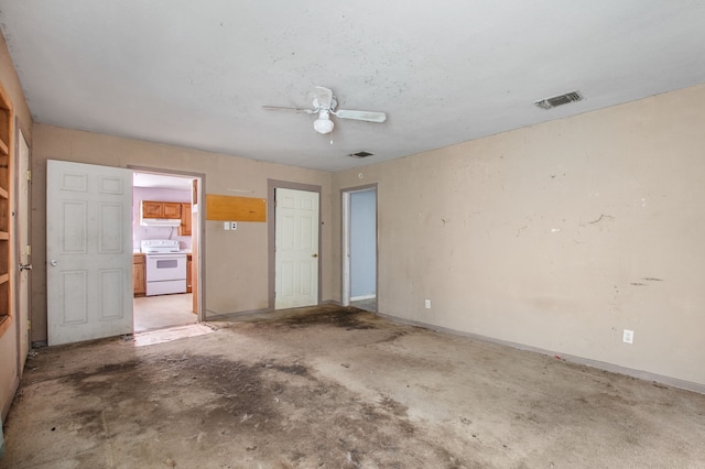 spare room featuring baseboards, visible vents, ceiling fan, and unfinished concrete flooring