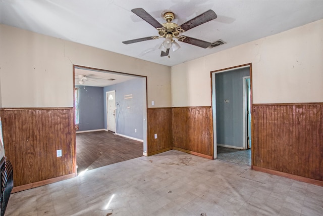 spare room featuring a wainscoted wall and tile patterned floors