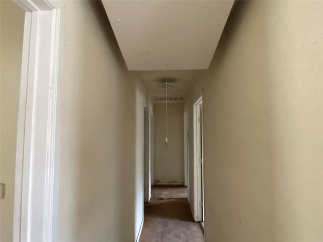 corridor featuring attic access and visible vents