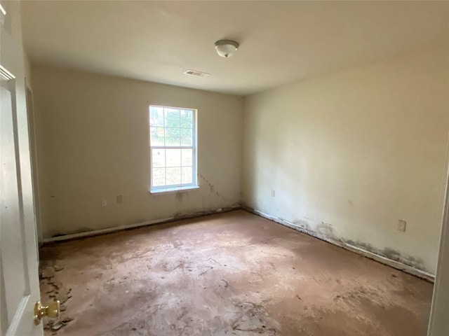 empty room with unfinished concrete flooring and visible vents