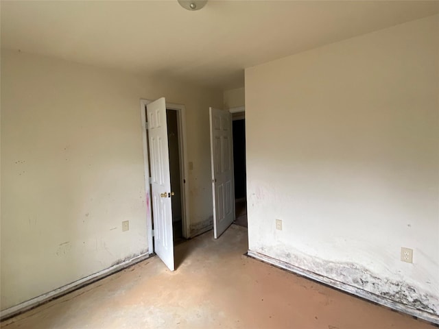 unfurnished room featuring concrete flooring