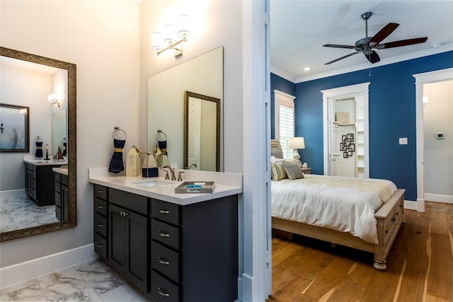 ensuite bathroom featuring marble finish floor, ornamental molding, connected bathroom, ceiling fan, and baseboards