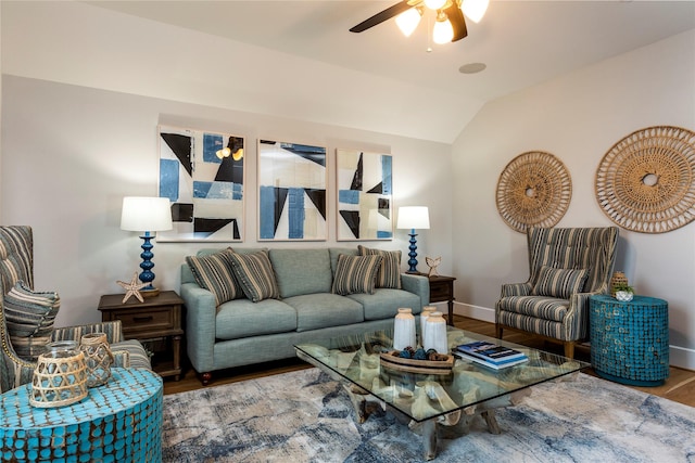 living room with a ceiling fan, lofted ceiling, baseboards, and wood finished floors