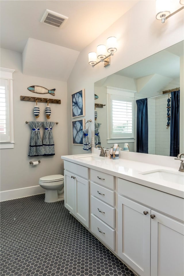 bathroom with a healthy amount of sunlight, visible vents, and a sink