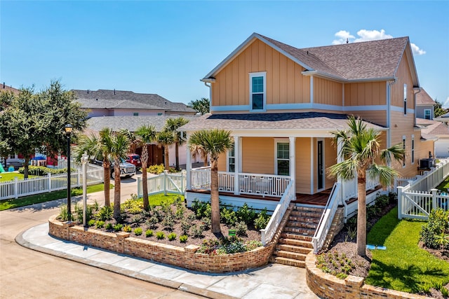 view of front of home with a gate, fence, a porch, and board and batten siding