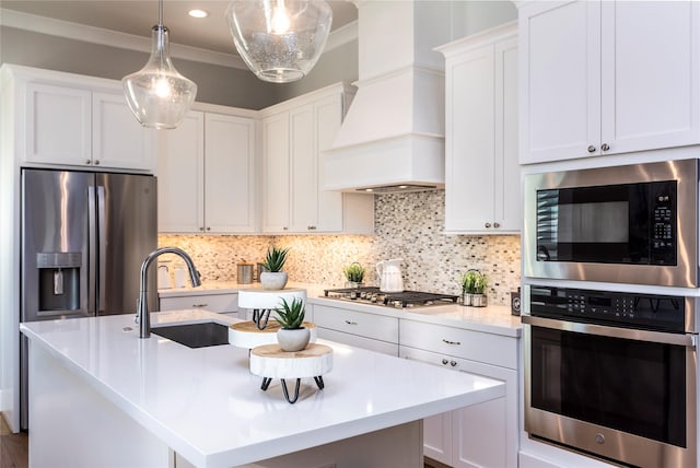 kitchen with light countertops, backsplash, appliances with stainless steel finishes, ornamental molding, and premium range hood