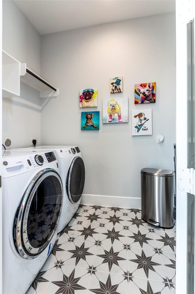 laundry room featuring laundry area, separate washer and dryer, light floors, and baseboards