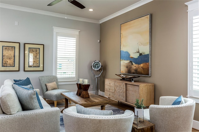 living area featuring baseboards, a ceiling fan, ornamental molding, wood finished floors, and recessed lighting