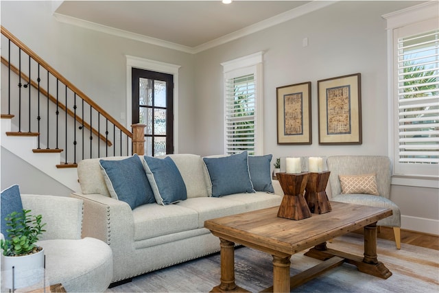 living room with ornamental molding, stairs, and wood finished floors