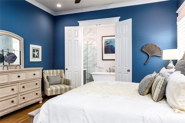 bedroom featuring dark wood-style flooring, ensuite bath, and crown molding