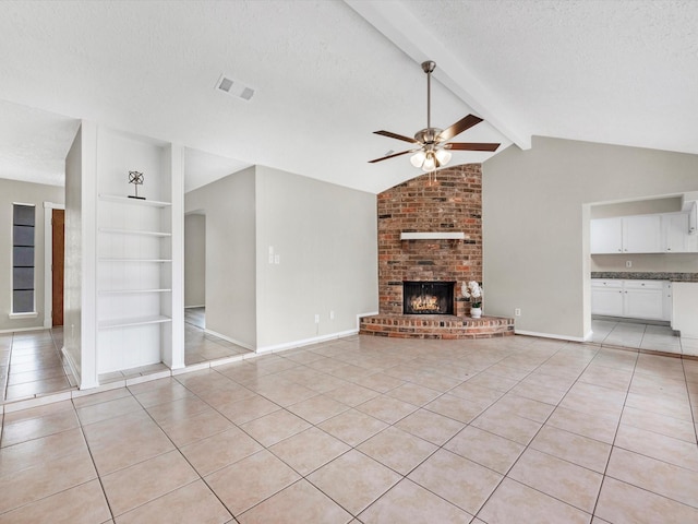 unfurnished living room with light tile patterned flooring, built in features, and a textured ceiling