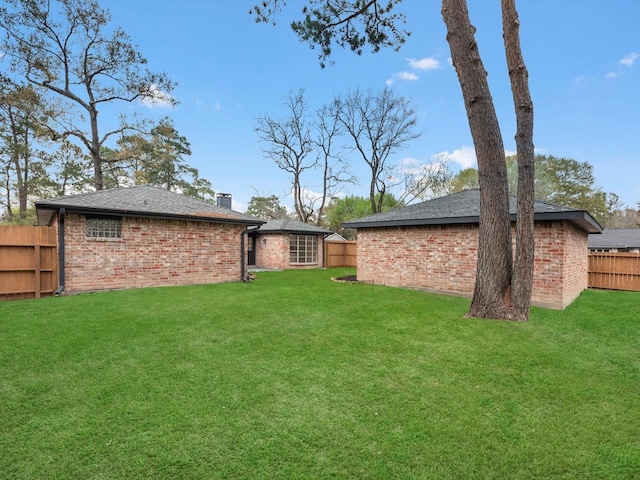 view of yard with an outdoor structure and fence