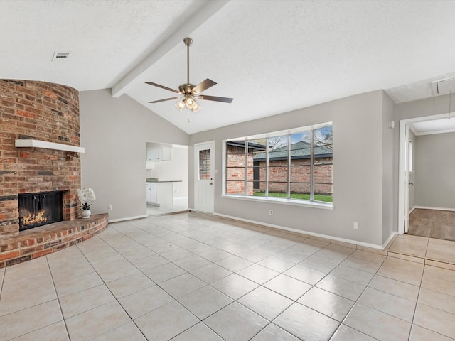 unfurnished living room with visible vents, a ceiling fan, a textured ceiling, tile patterned flooring, and a brick fireplace