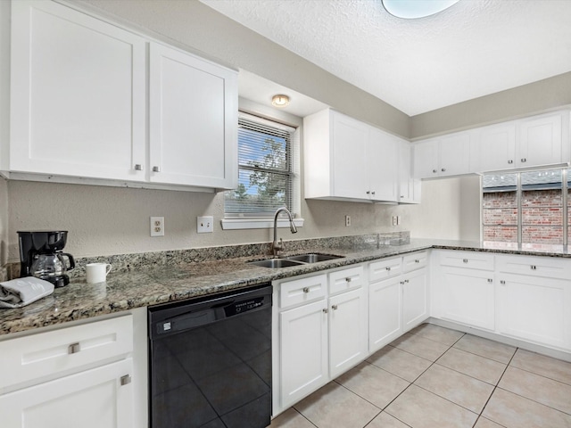 kitchen with white cabinets, black dishwasher, and a sink