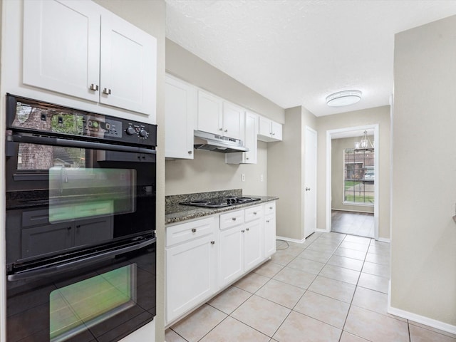 kitchen featuring under cabinet range hood, white cabinetry, black appliances, and light tile patterned flooring