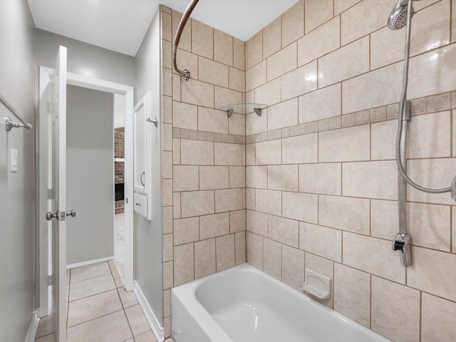 bathroom featuring tile patterned floors, baseboards, and bathtub / shower combination