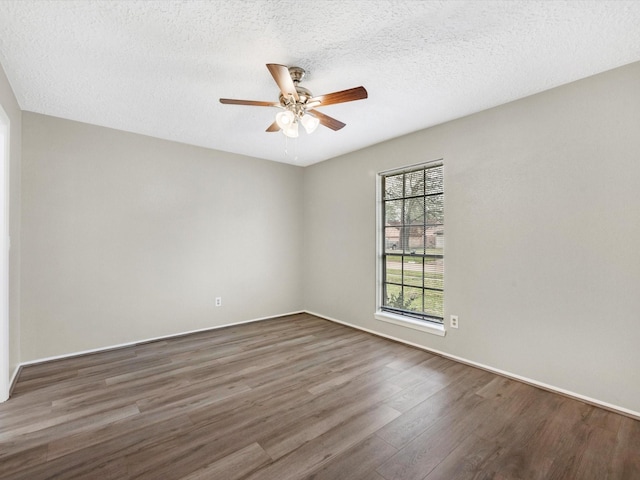 spare room with ceiling fan, a textured ceiling, and wood finished floors