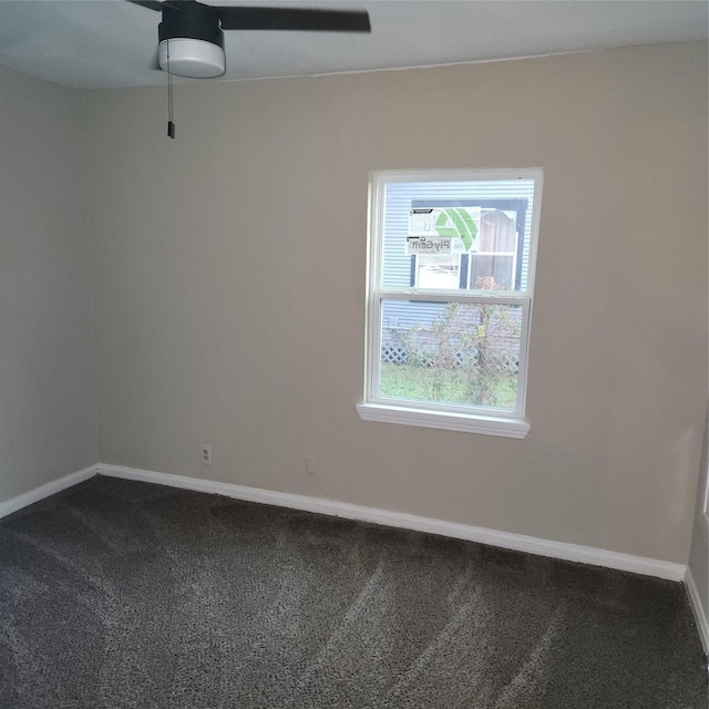 empty room with baseboards and dark carpet