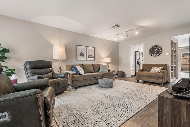 living room featuring wood finished floors and visible vents