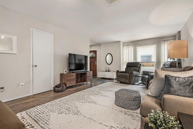 living room with baseboards and dark wood finished floors