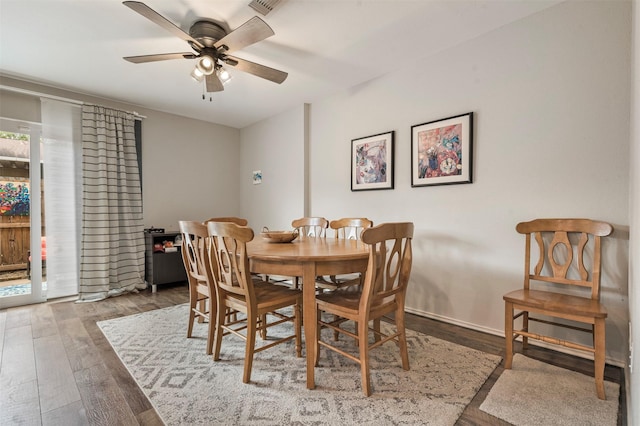 dining space with ceiling fan and wood finished floors