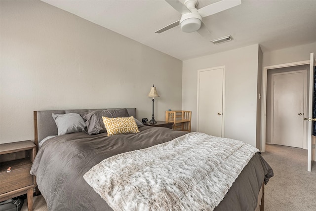 bedroom with ceiling fan, visible vents, and light colored carpet