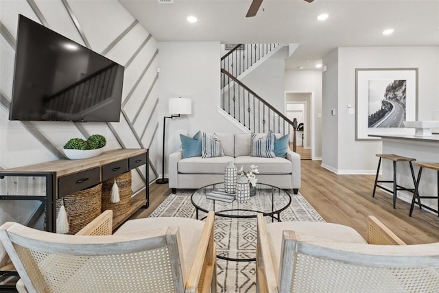 living area with stairs, recessed lighting, a ceiling fan, and wood finished floors