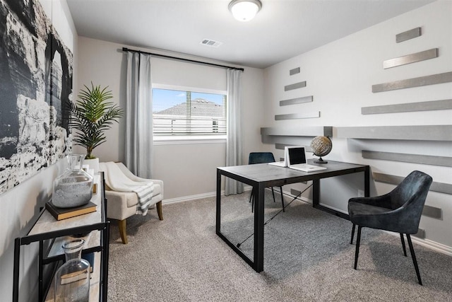 carpeted office space featuring visible vents and baseboards