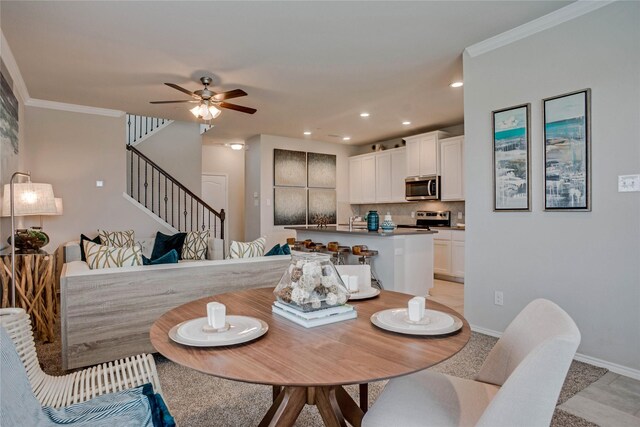 dining area featuring baseboards, ornamental molding, stairway, and recessed lighting