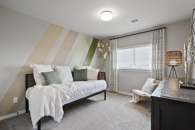 bedroom featuring light carpet, visible vents, and baseboards