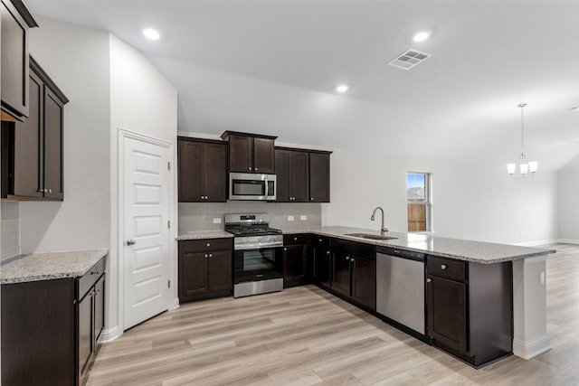 13324 Silver Egret Ln, Texas City, TX 77568 - kitchen with stainless steel appliances, visible vents, a sink, light wood-type flooring, and a peninsula