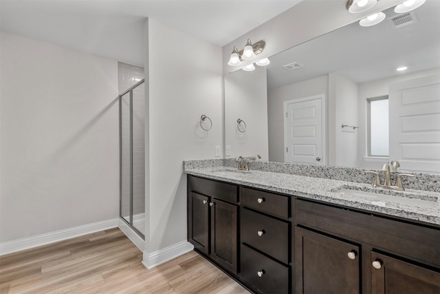 13324 Silver Egret Ln, Texas City, TX 77568 - full bath with visible vents, a sink, a shower stall, and wood finished floors