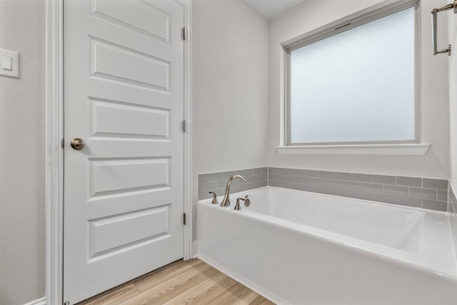 13324 Silver Egret Ln, Texas City, TX 77568 - bathroom featuring a garden tub and wood finished floors
