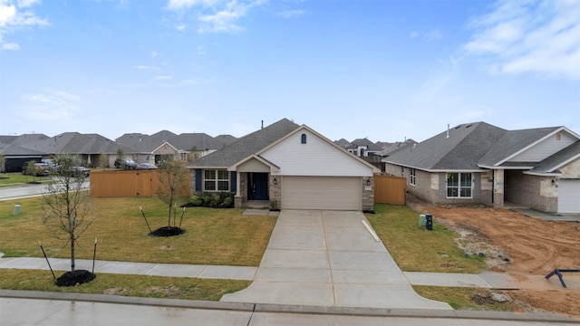 view of front of property featuring brick siding, fence, a garage, driveway, and a front lawn