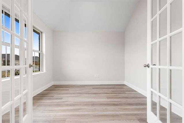 13324 Silver Egret Ln, Texas City, TX 77568 - spare room featuring light wood-style flooring, baseboards, and french doors