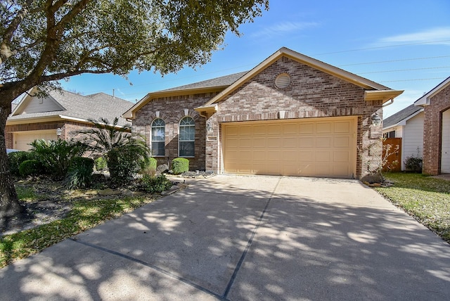 view of front of home with a garage, concrete driveway, and brick siding