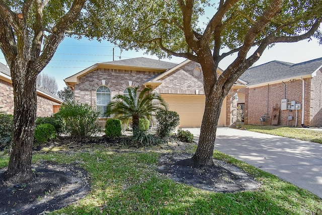 view of front of house with driveway, brick siding, roof with shingles, and an attached garage