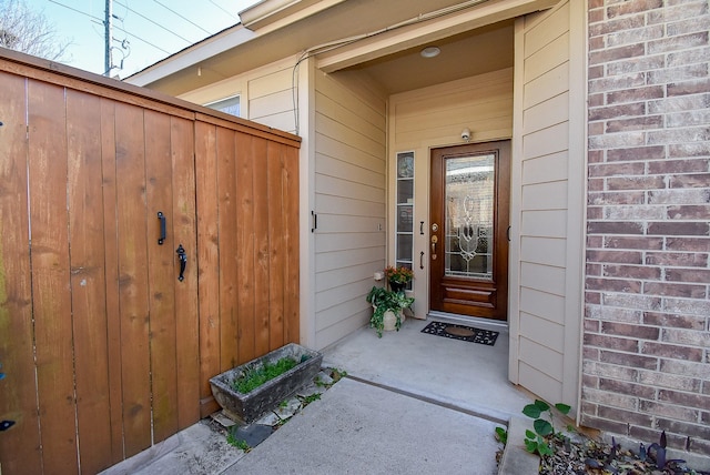 entrance to property featuring brick siding