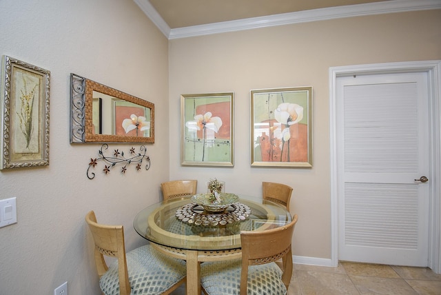 dining space featuring baseboards, crown molding, and tile patterned floors