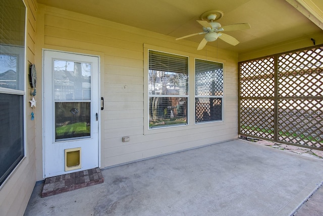 property entrance featuring a patio area and a ceiling fan