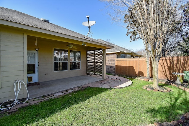 view of yard with a patio area, fence, and ceiling fan