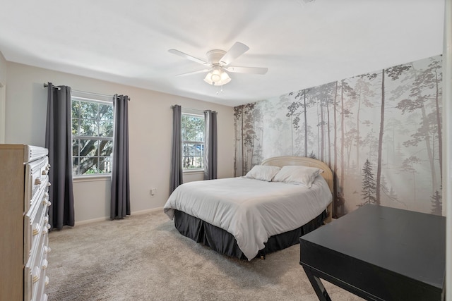 bedroom featuring light carpet, ceiling fan, and baseboards