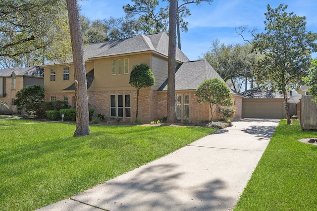 traditional-style house featuring brick siding, a garage, a front yard, and roof with shingles