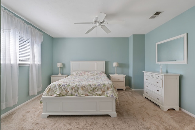 bedroom with ceiling fan, light colored carpet, visible vents, and baseboards